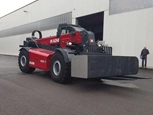 Telehandler in front of a building